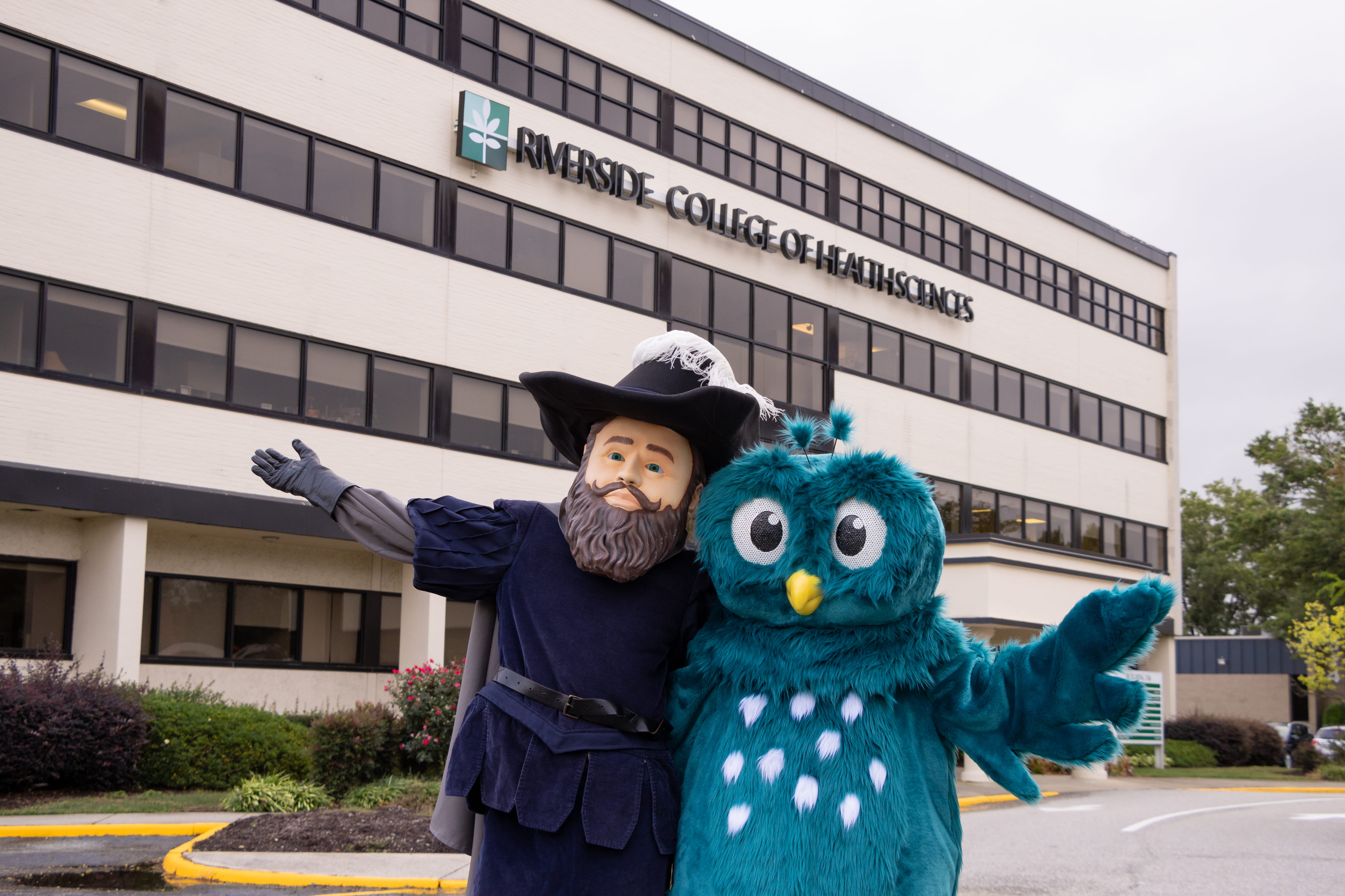 Two mascots in front of RCHS Admin Building